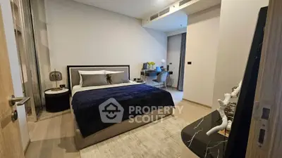 Modern bedroom with stylish decor and workspace, perfect for urban living.