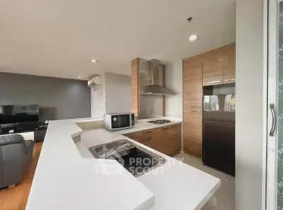 Modern open-layout kitchen with sleek appliances and spacious living area