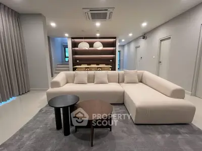 Modern living room with stylish sectional sofa and elegant dining area