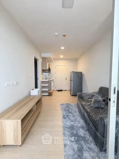 Modern living room with sleek furniture and open kitchen layout