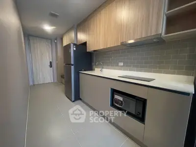 Modern kitchen with sleek cabinetry and built-in appliances in a compact layout.