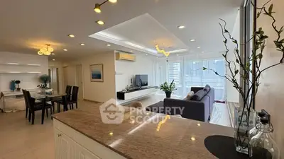 Spacious modern living room with open layout and elegant decor in a high-rise apartment.
