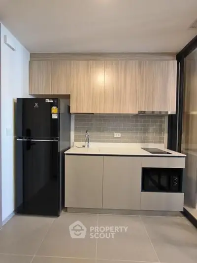 Modern kitchen with sleek cabinetry and built-in appliances in a stylish apartment.