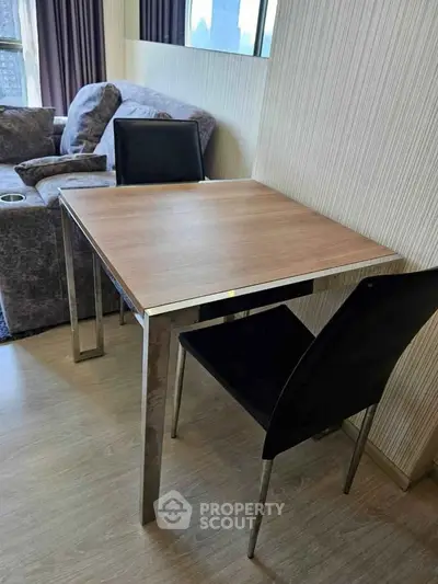 Modern living room with stylish furniture and wooden flooring, perfect for cozy gatherings.