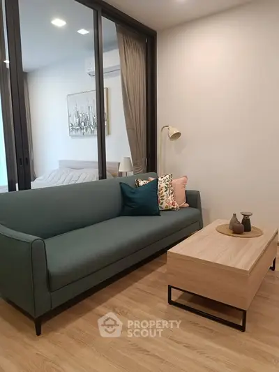 Modern living room with stylish sofa and wooden coffee table in a cozy apartment setting.