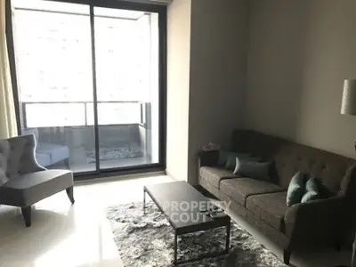 Modern living room with large window and stylish furniture in a high-rise apartment.