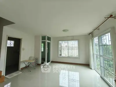 Spacious and bright living room with large windows and modern design