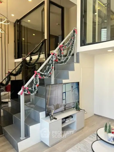 Modern duplex living room with stylish staircase and festive decor