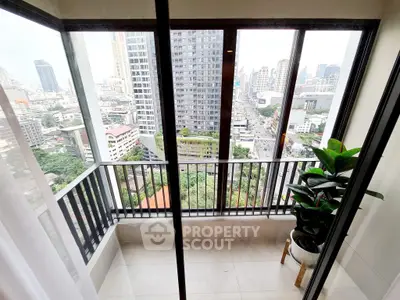 Stunning city view from modern high-rise balcony with sleek glass railing.