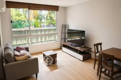 Bright and cozy living room with modern furniture and large window view.