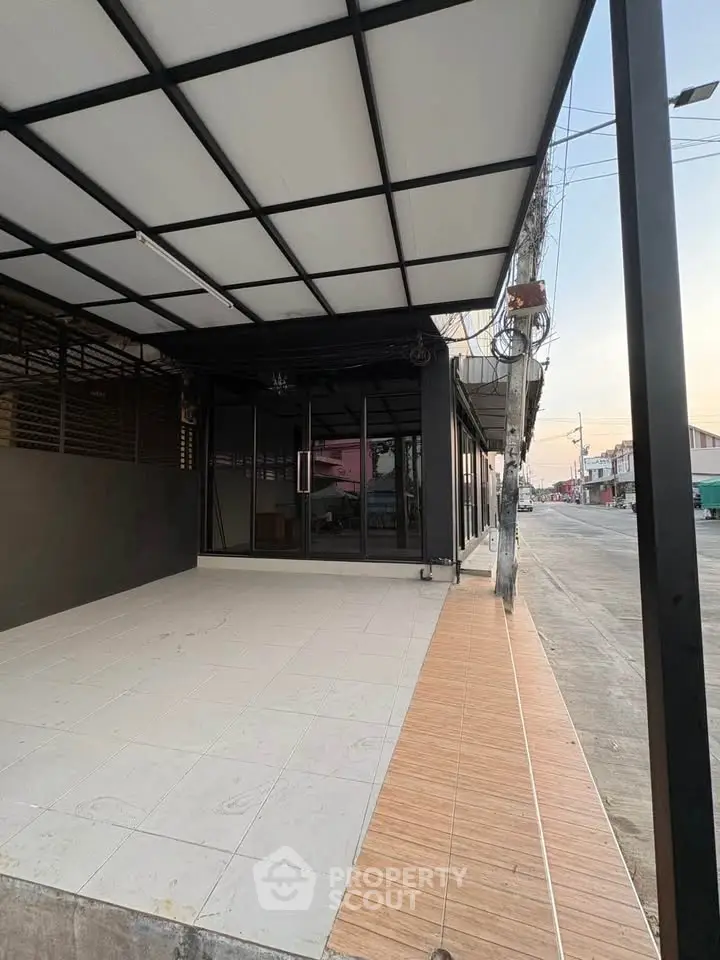 Modern commercial property with sleek exterior design and spacious tiled entrance.