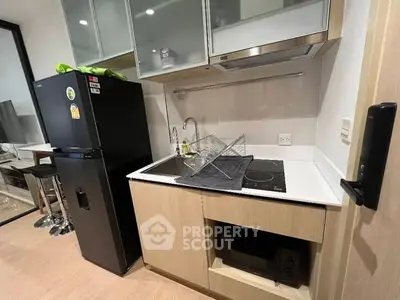 Modern compact kitchen with sleek appliances and efficient storage solutions.