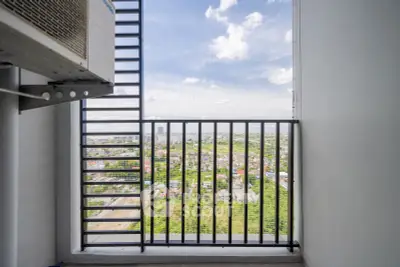 Stunning high-rise balcony view overlooking lush green landscape and city skyline, perfect for urban living.