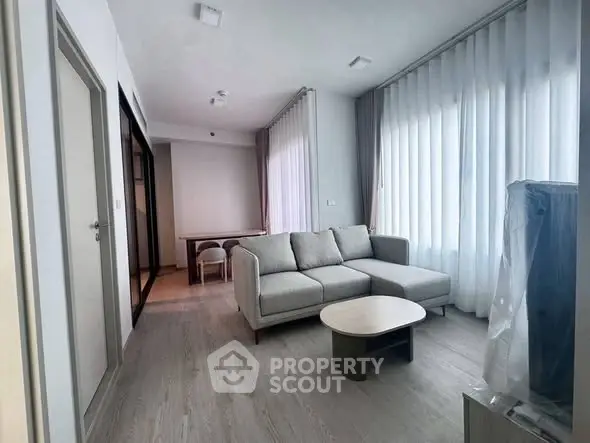 Modern living room with stylish furniture and large windows for natural light