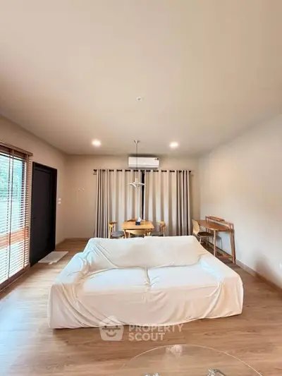 Spacious living room with modern decor and natural light