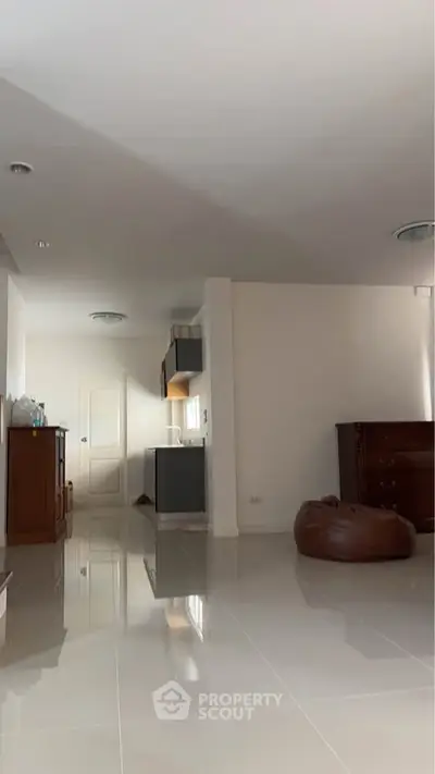 Spacious modern living area with sleek flooring and minimalist decor, perfect for contemporary living.