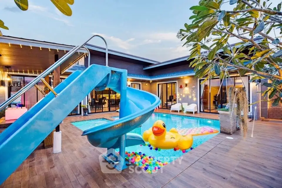 Luxurious modern villa with private pool and slide, perfect for family entertainment.