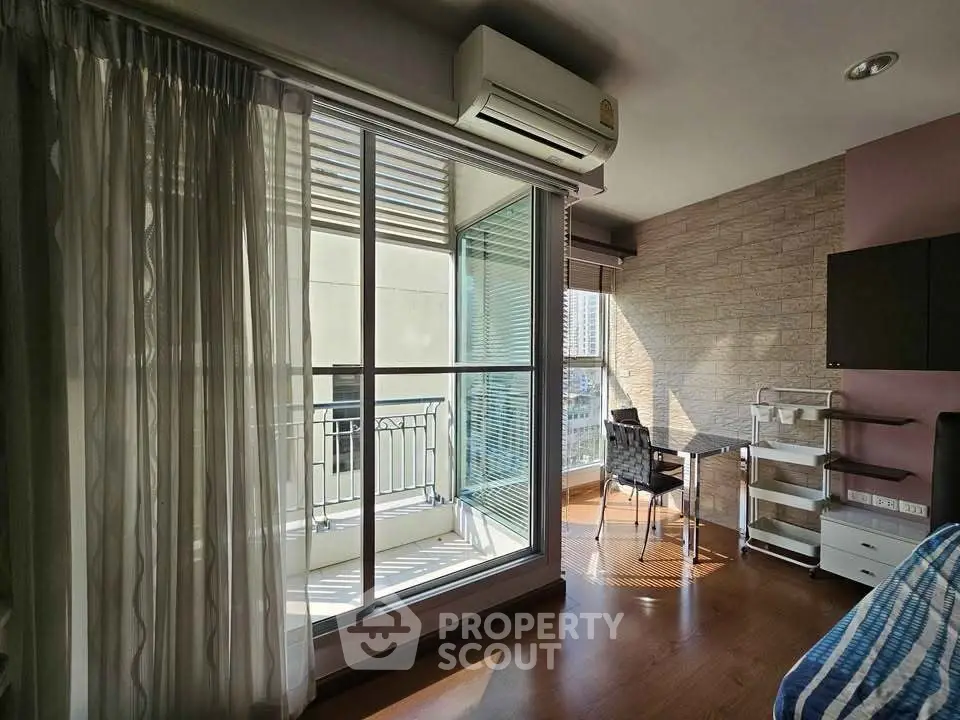 Modern bedroom with balcony access and stylish decor in urban apartment