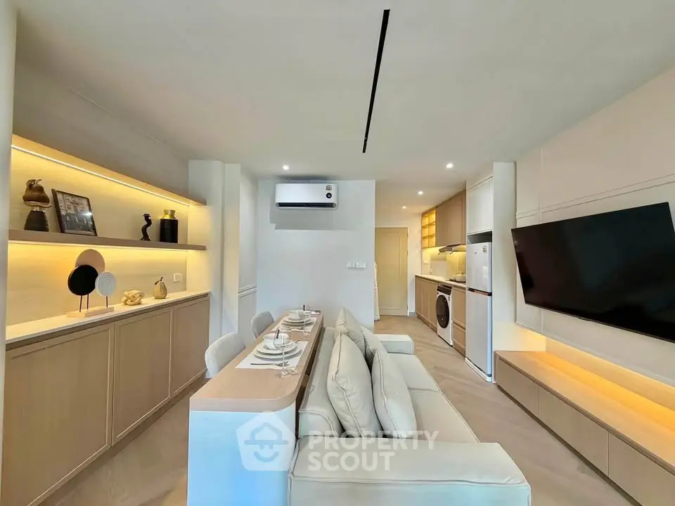 Modern living room with sleek furniture and integrated kitchen appliances