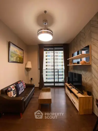 Modern living room with stylish decor and city view from large window.