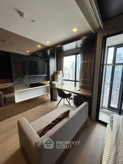 Modern living room with city view, featuring sleek furniture and large windows for natural light.