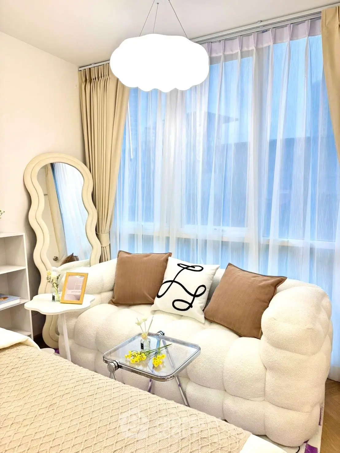 Cozy living room with plush sofa, elegant mirror, and soft lighting