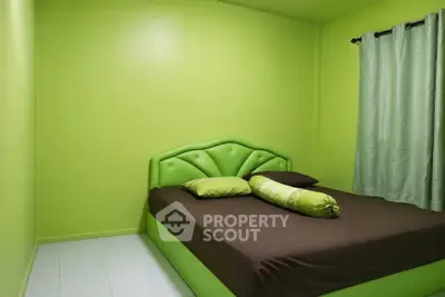Vibrant green bedroom with modern bed and matching curtains, perfect for a refreshing living space.