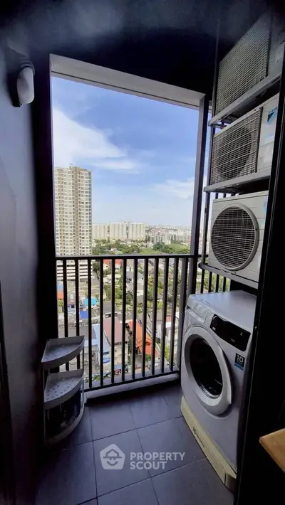 High-rise apartment balcony with washing machine and stunning city view.