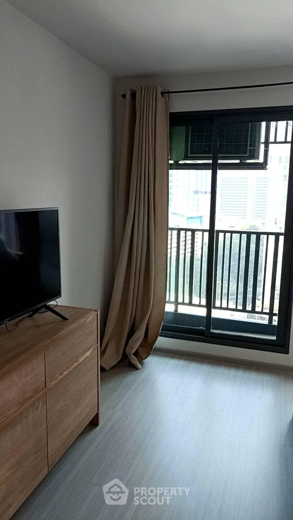 Modern living room with balcony view and sleek wooden furniture