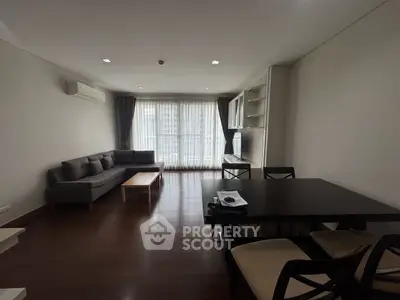 Spacious living room with modern furniture and large windows