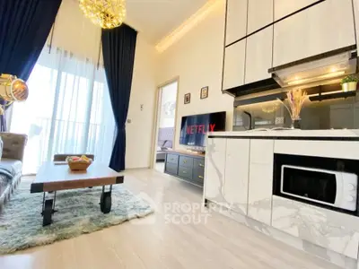 Modern living room with open kitchen, stylish decor, and natural light in a contemporary apartment.