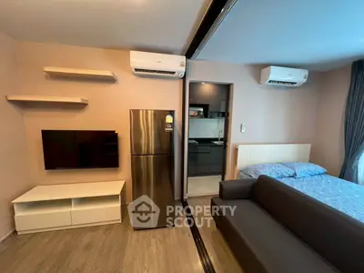 Modern studio apartment with sleek design, featuring a cozy living area, compact kitchen, and stylish furnishings.
