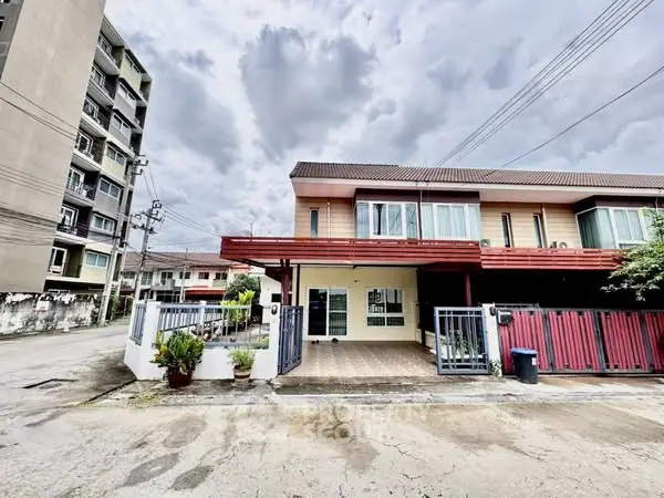 Charming townhouse with spacious driveway and modern facade in a serene neighborhood.