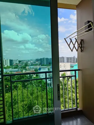 Stunning balcony view with lush greenery and cityscape, perfect for urban living.