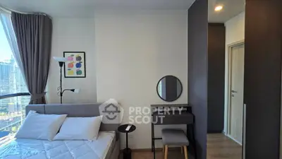 Modern bedroom with city view, featuring stylish decor and natural light.