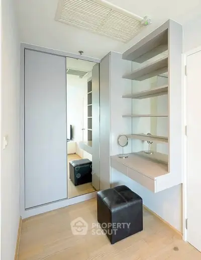 Modern dressing area with mirror and shelves in a stylish apartment