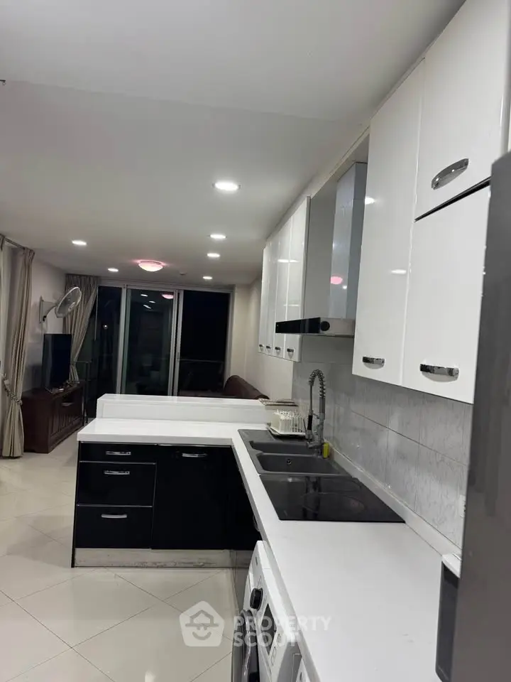 Modern kitchen with sleek black and white cabinetry and appliances