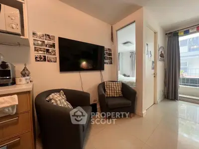 Cozy living room with modern decor and wall-mounted TV in a stylish apartment.