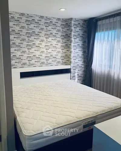 Modern bedroom with stylish brick accent wall and large window