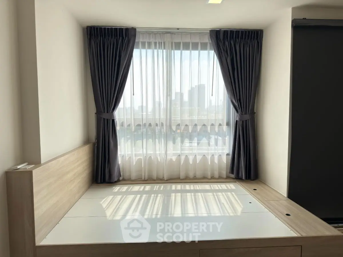 Cozy bedroom with city view and elegant curtains