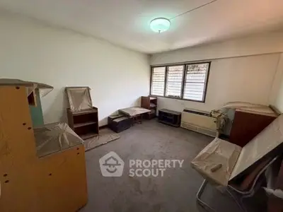 Spacious room with potential for customization, featuring large windows and ample natural light.