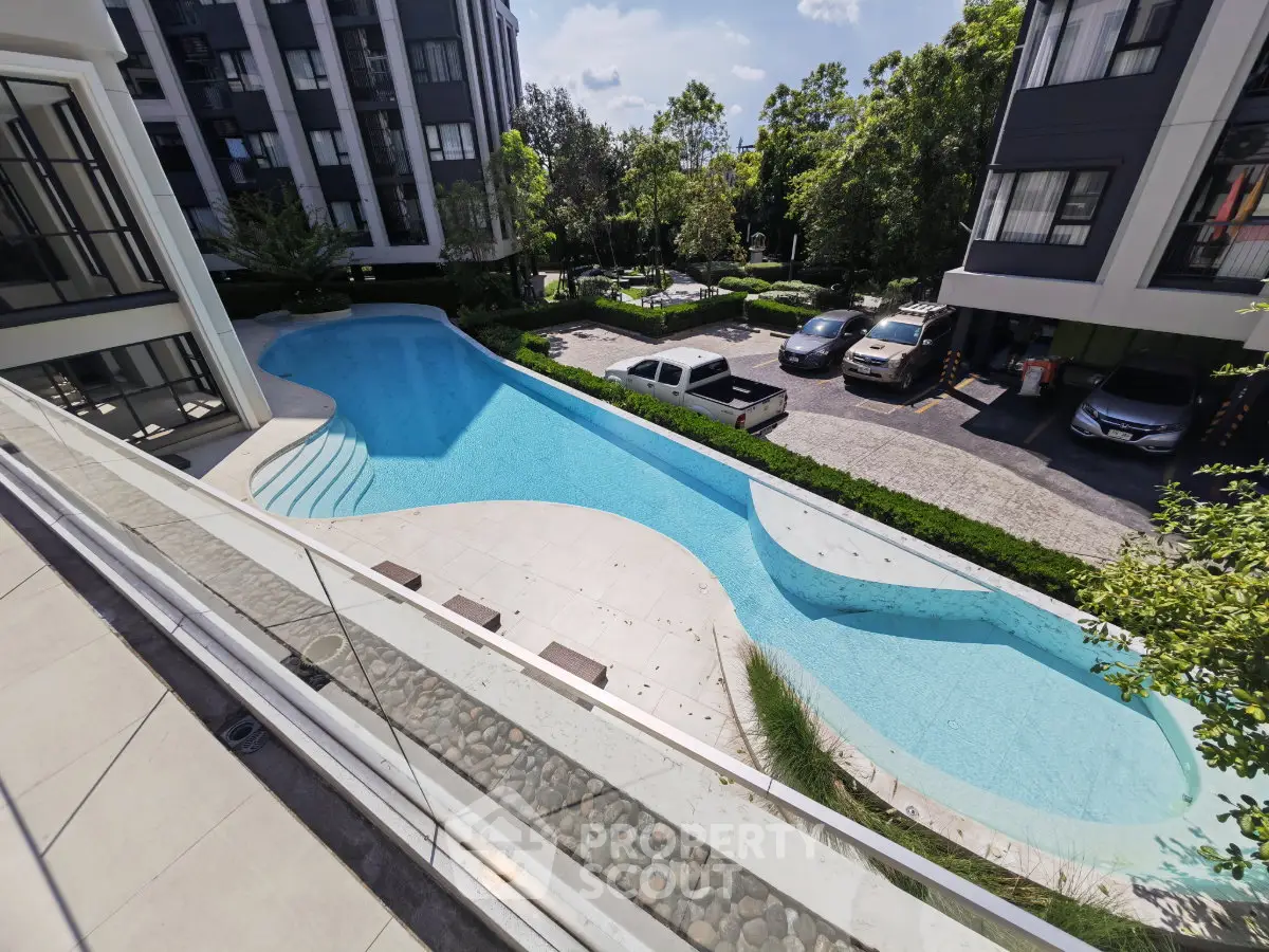 Luxurious condominium with stunning pool view and lush greenery, perfect for relaxation and modern living.