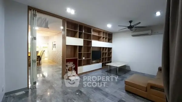 Spacious modern living room with built-in shelving and open layout