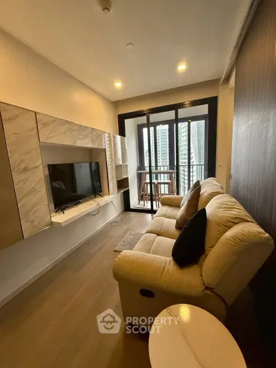 Modern living room with cozy sofa and balcony view in high-rise apartment