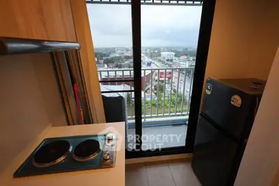 Modern kitchen with balcony view in high-rise apartment