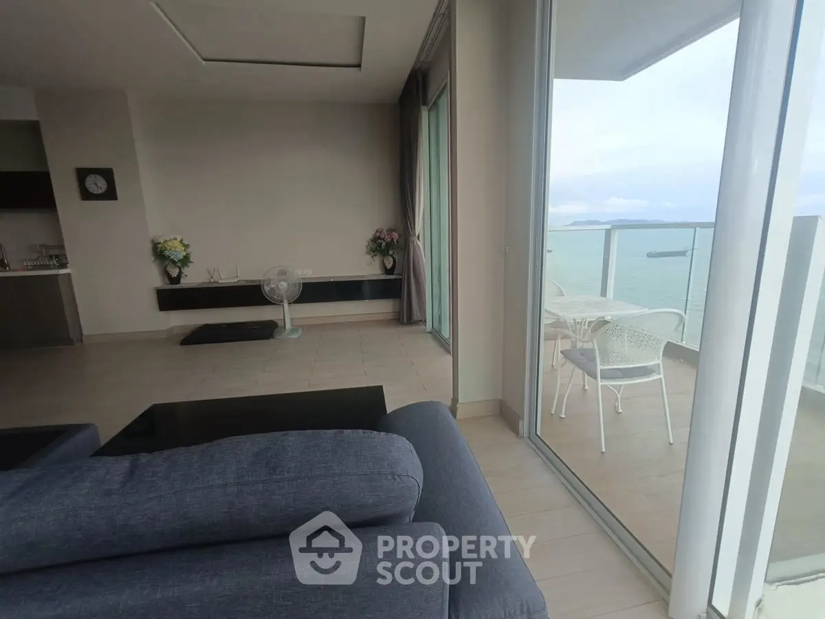 Spacious living room with ocean view balcony in modern apartment