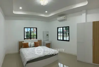 Spacious modern bedroom with stylish decor and natural light
