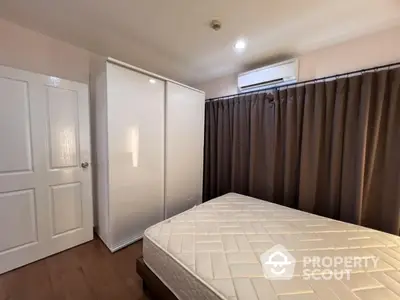 Cozy bedroom with modern wardrobe and air conditioning, perfect for restful nights.