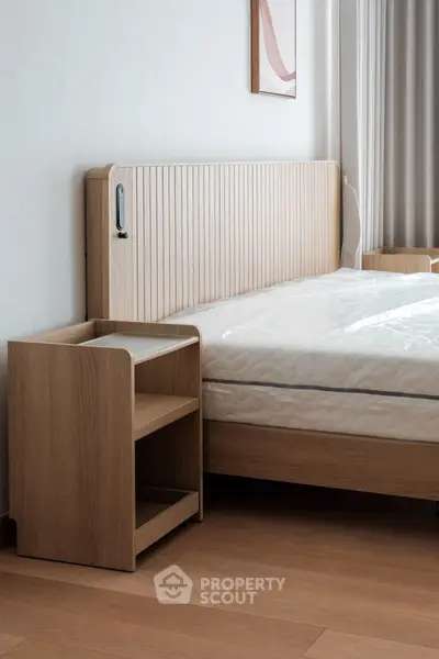 Modern bedroom with stylish wooden headboard and side table