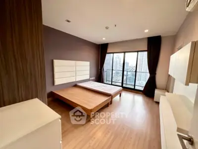 Spacious modern bedroom with city view and large windows